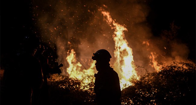 Wildfire Firefighters tackle a forest fire around the village of Eiriz in Baiao north of Portugal on July 15 2022