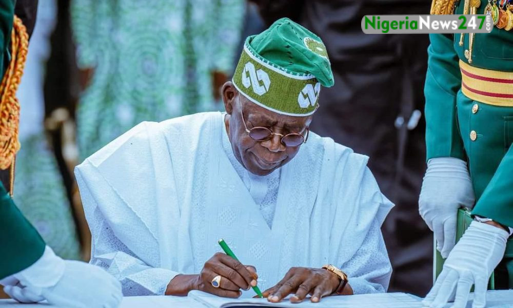 Bola Tinubu Signing a document