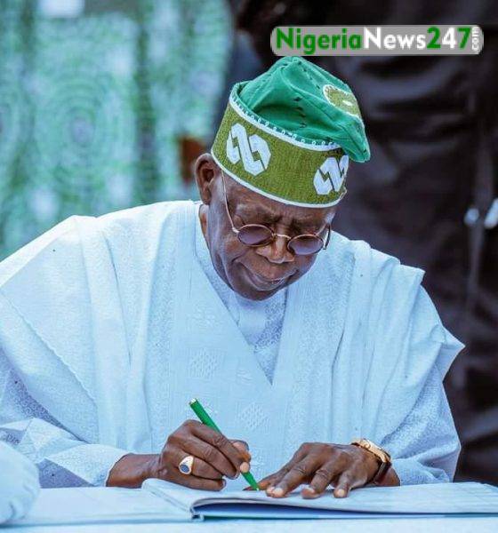 Bola Tinubu Signing a document