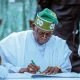 Bola Tinubu Signing a document